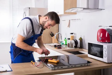 Repairman repairing cooktop glass