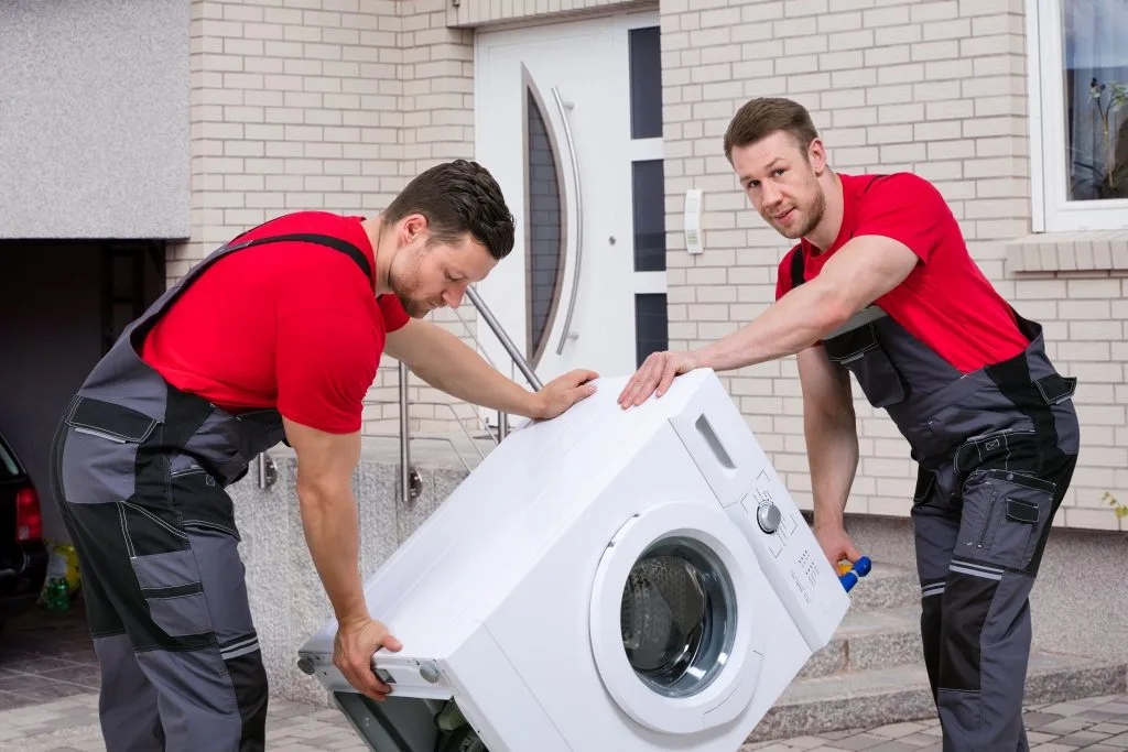 Delivery man picking up dryer, washer in Calgary
