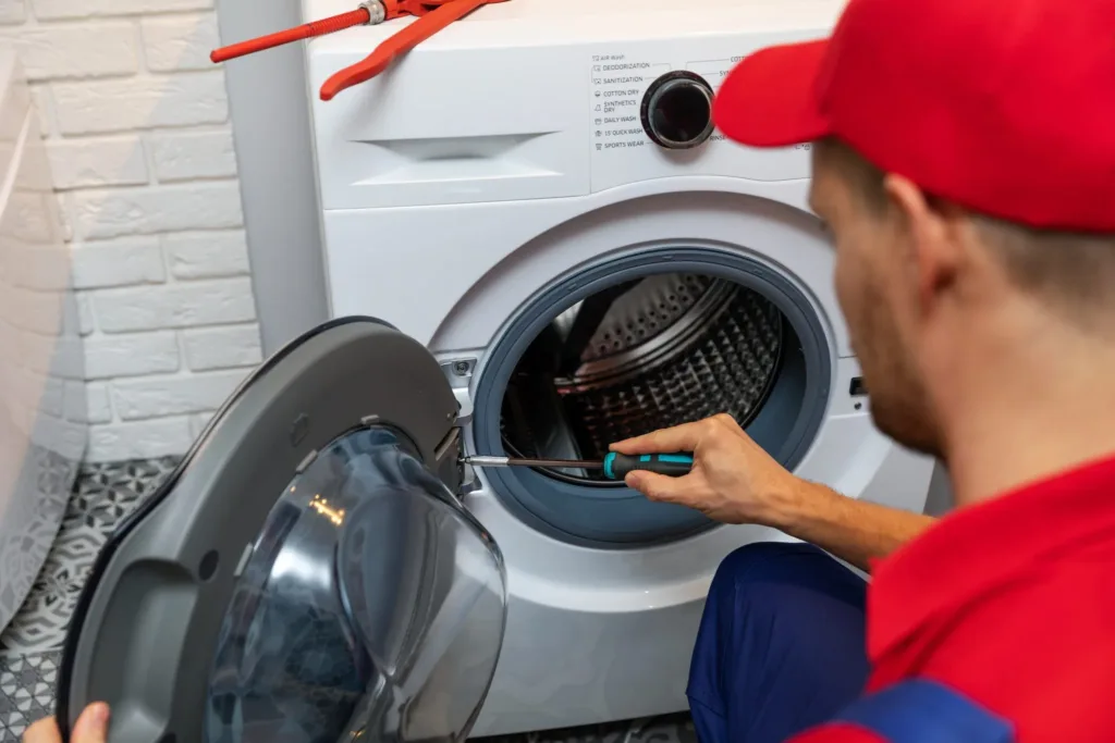 SMS Appliances repairman expertly repairing a washer in Saskatoon - Trusted appliance repair services for seamless and efficient solutions.